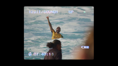 a man riding a wave on top of a surfboard