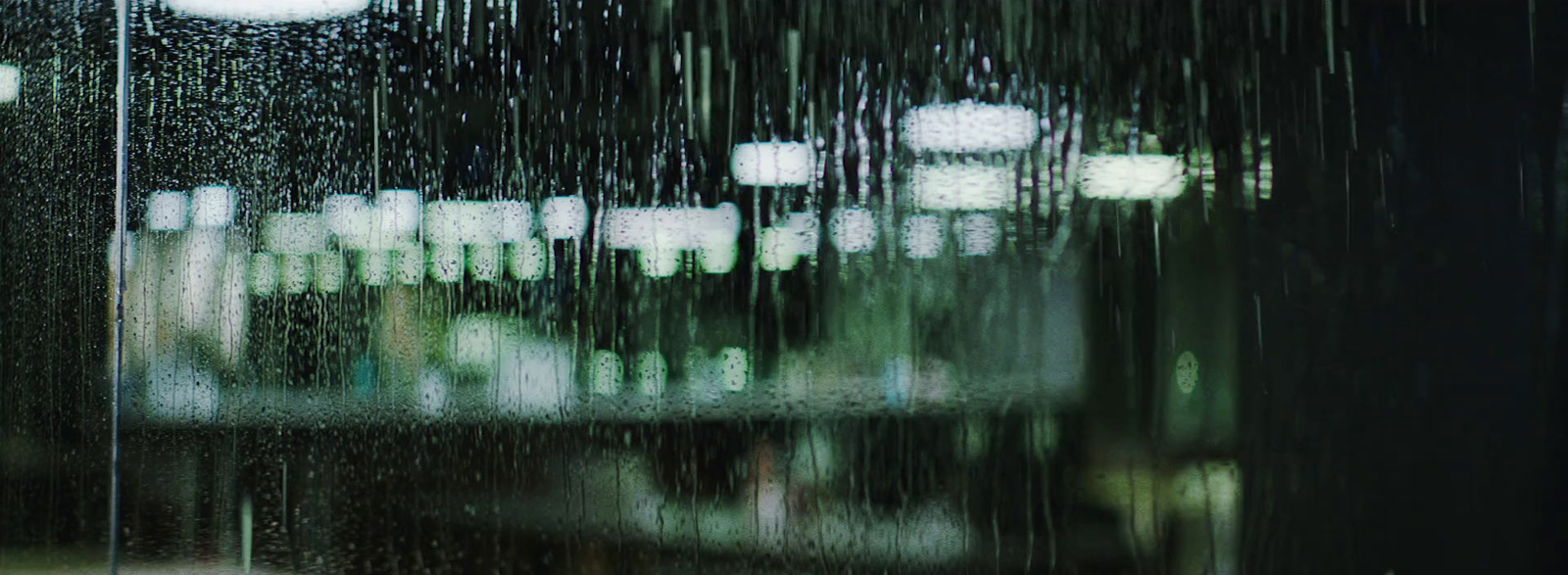 a view of a building through a rain covered window