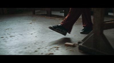 a person stepping on a wooden bench in the snow