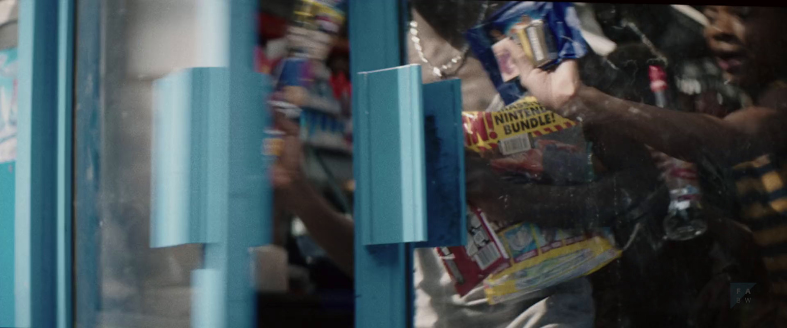 a man holding a bag of candy in front of a store window