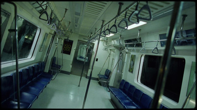 a subway car with blue seats and metal railings