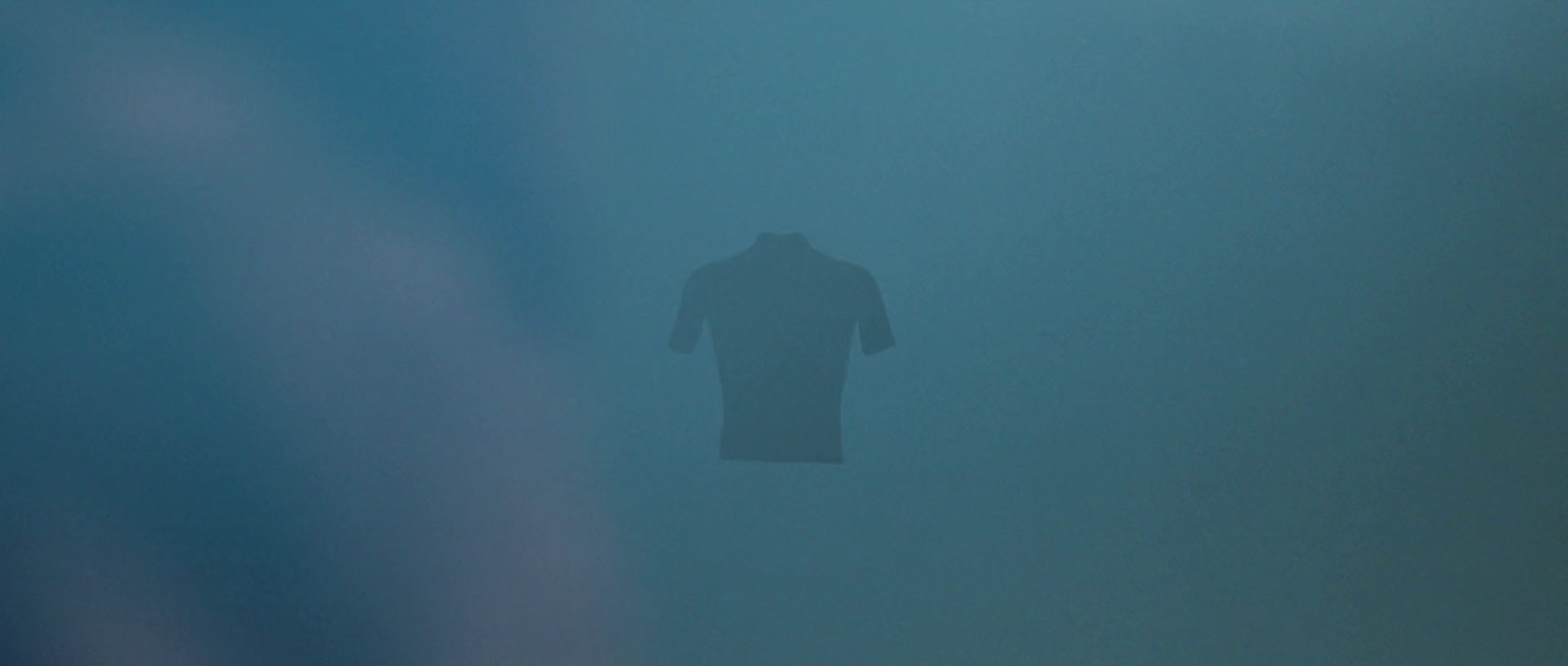 a silhouette of a person standing in the fog