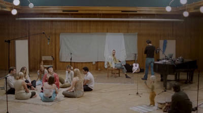 a group of people sitting on the floor in a room