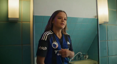 a girl is standing in front of a mirror