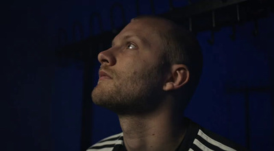 a man in a striped shirt looking up into the sky