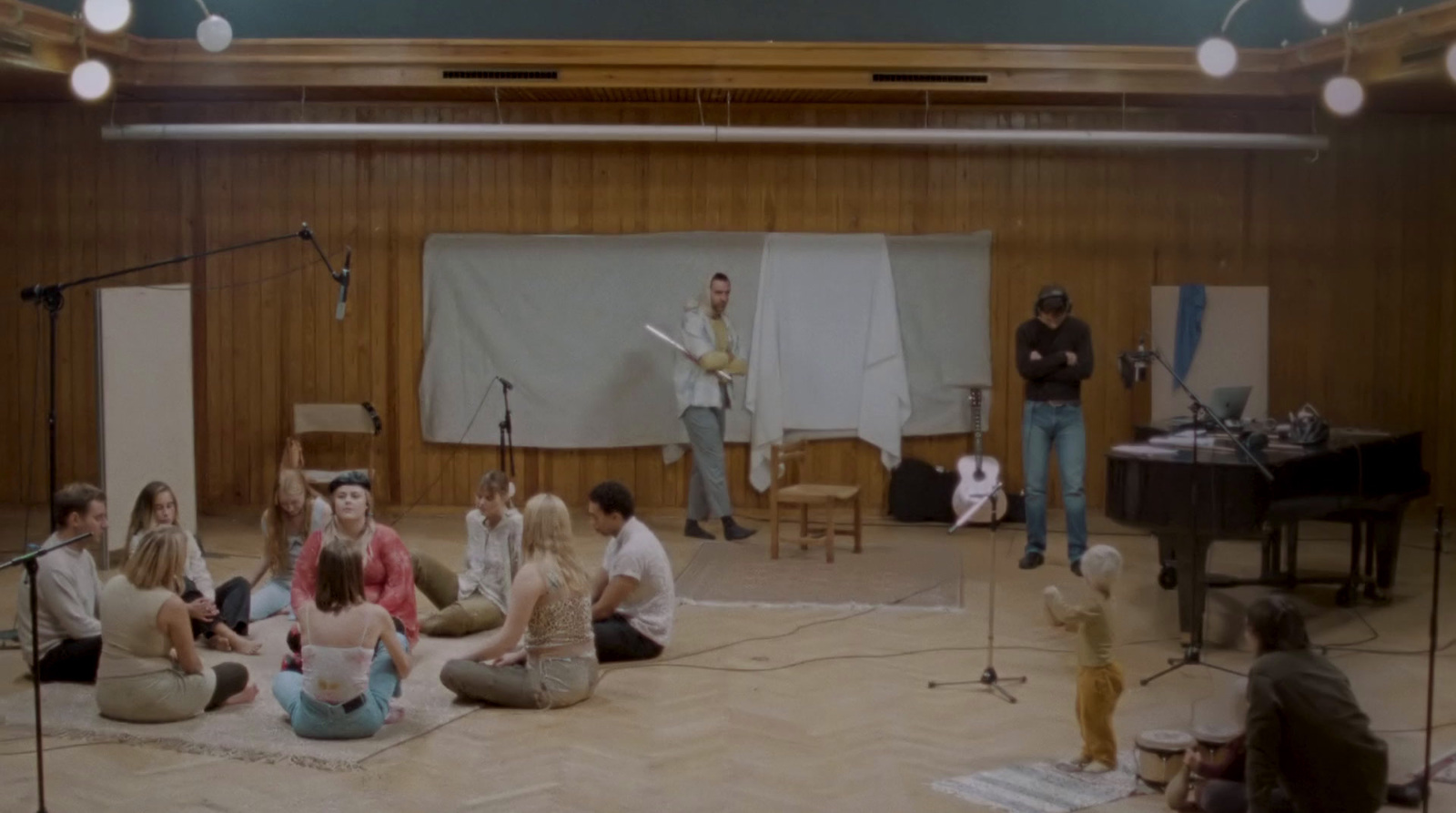 a group of people sitting on the floor in a room