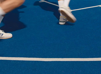 a man standing on top of a tennis court holding a racquet