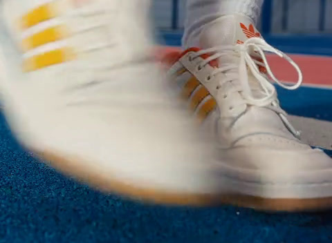 a close up of a person's white tennis shoe