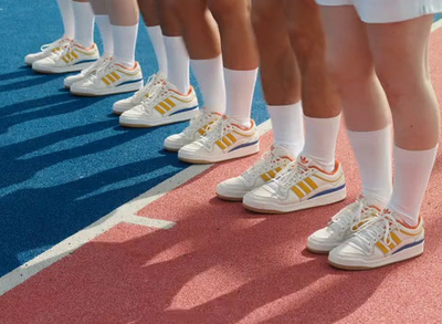 a group of people standing on top of a tennis court