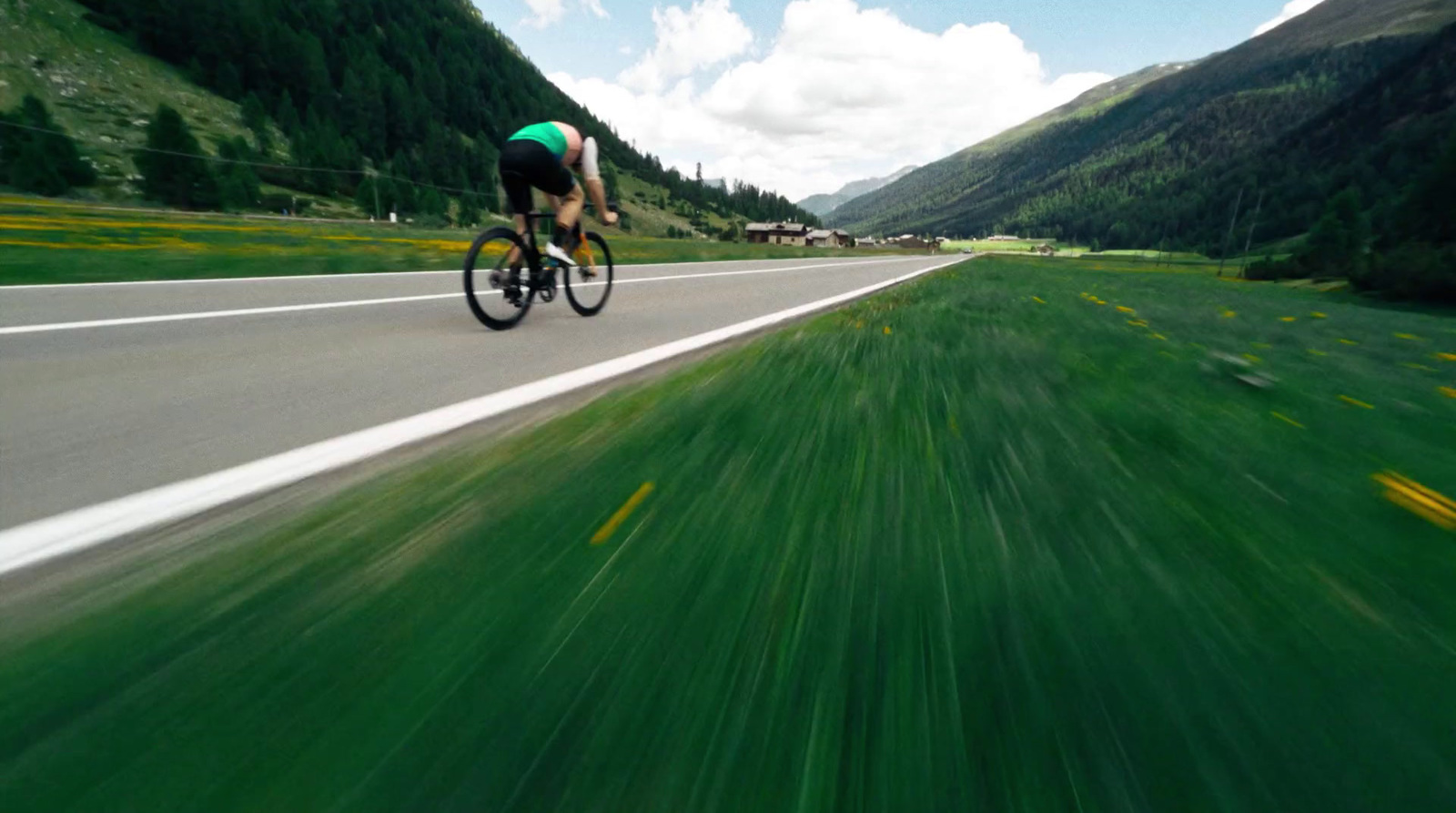 a man riding a bike down a curvy road