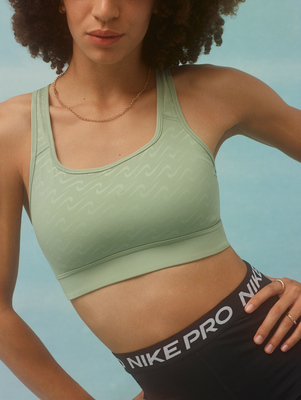 a woman in a sports bra top posing for a picture