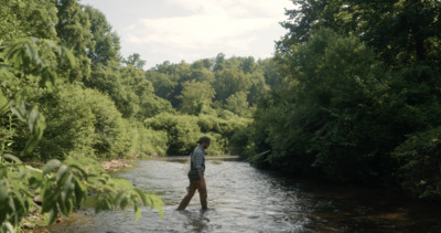 a man standing in the middle of a river