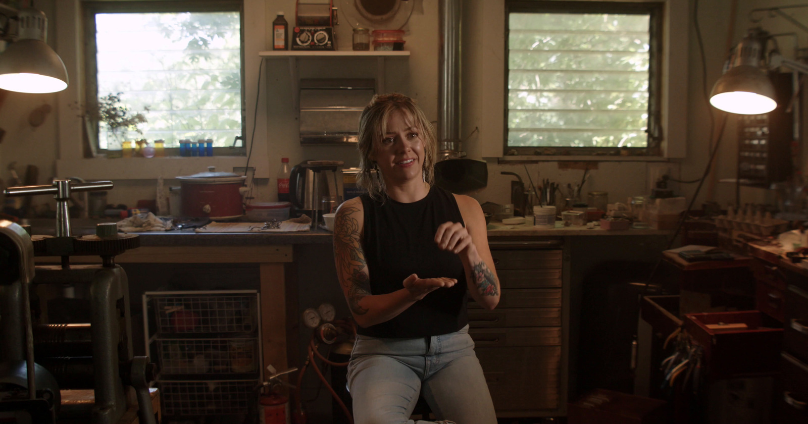 a woman sitting on a chair in a kitchen