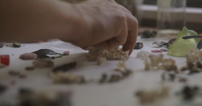 a person picking up a piece of food from a table