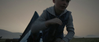 a young man holding a kite in his hands