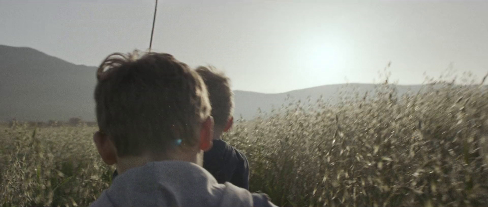 a couple of kids that are sitting in a field