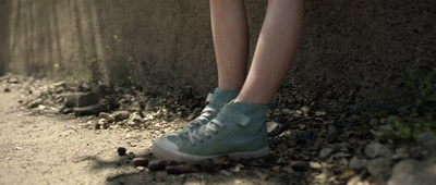 a person standing next to a stone wall