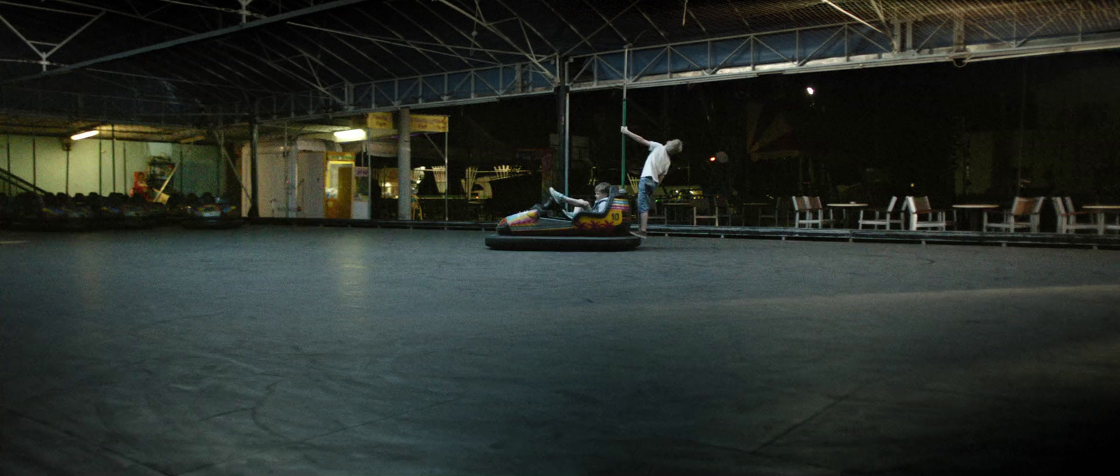 a man riding a bumper car on top of a floor