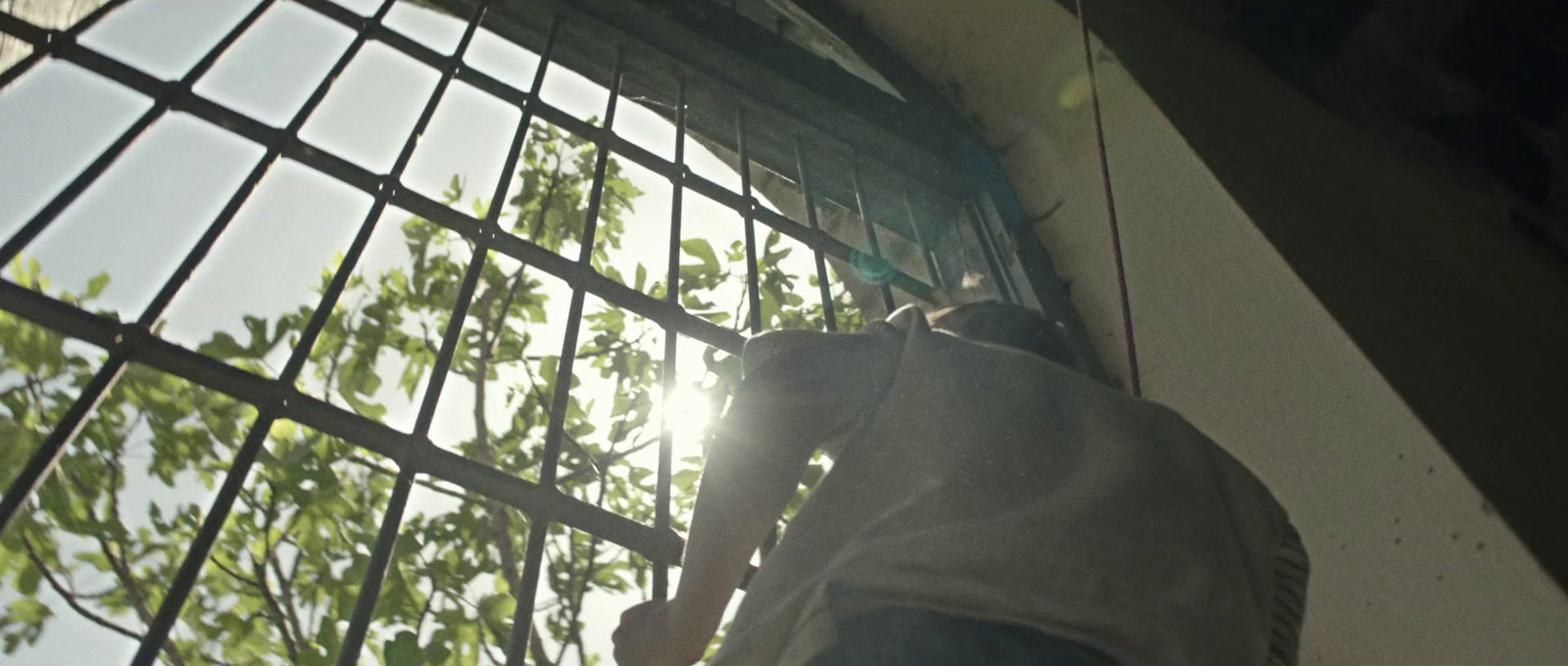 a man is climbing up the side of a building