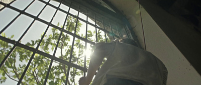 a man is climbing up the side of a building