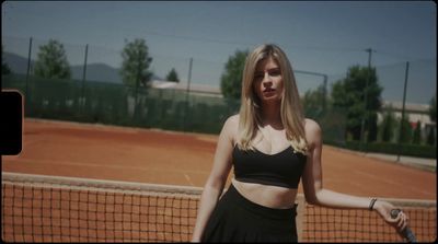 a woman holding a tennis racquet on a tennis court