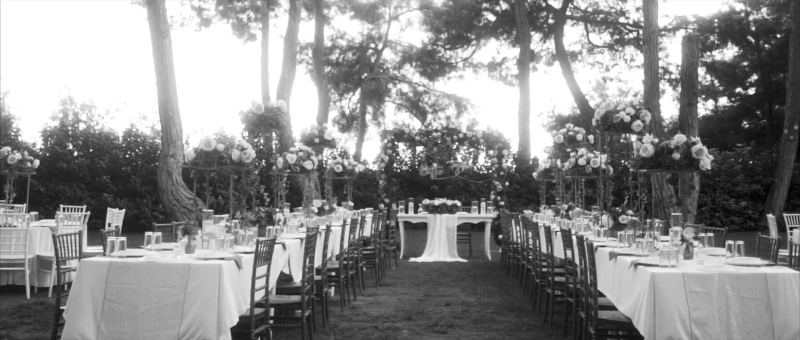 a black and white photo of tables and chairs