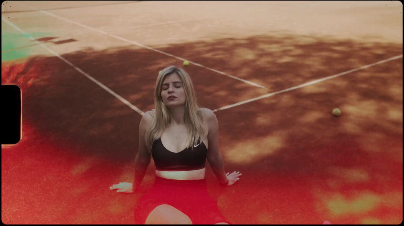 a woman is sitting on a tennis court