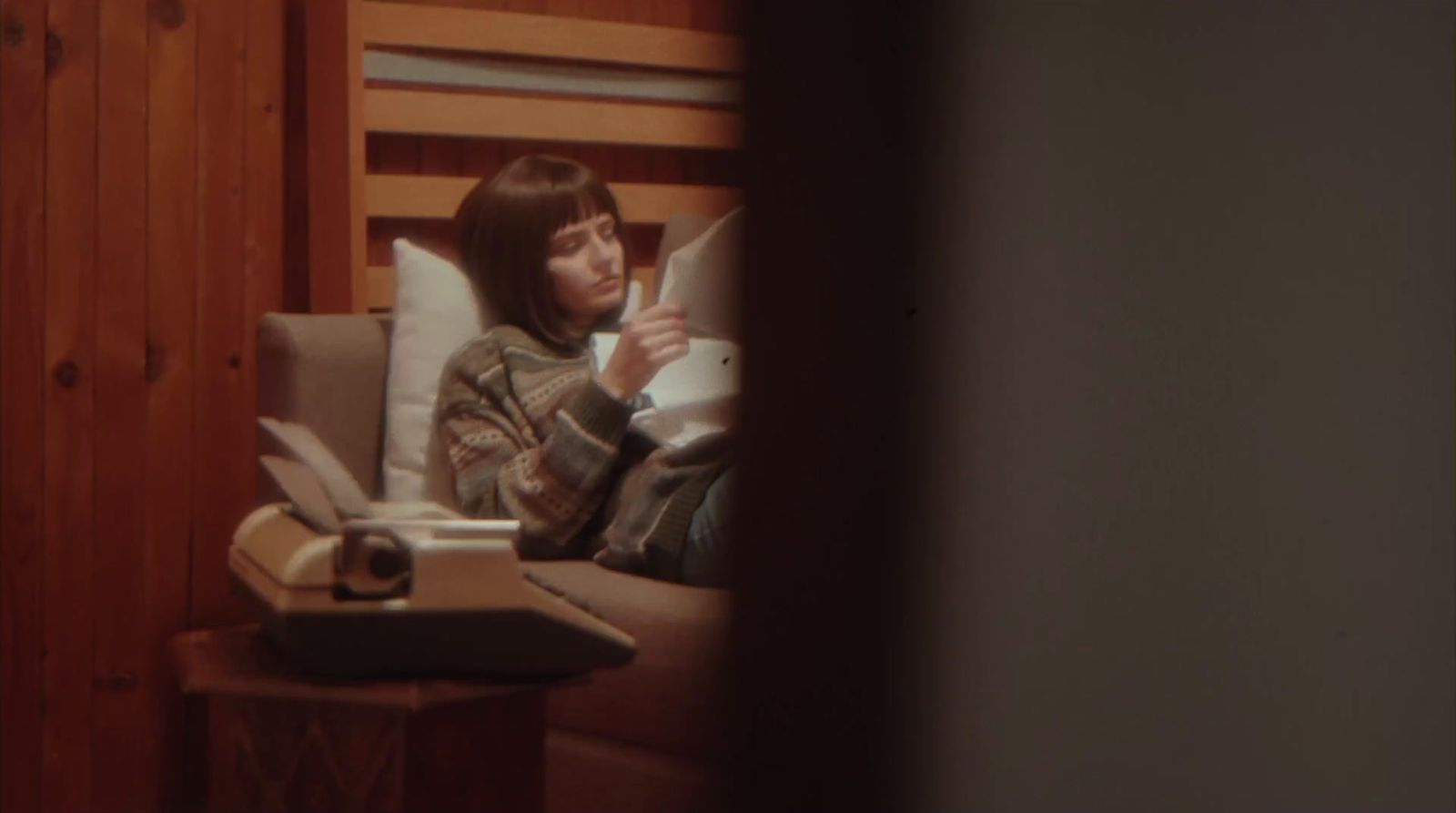 a woman sitting in a chair reading a book