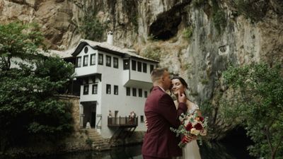 a bride and groom standing in front of a house