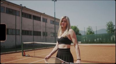 a woman holding a tennis racquet on a tennis court