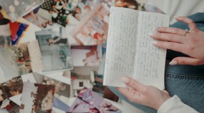 a woman is holding a book in her hands