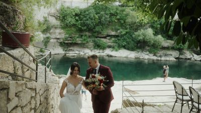 a bride and groom are walking down the stairs