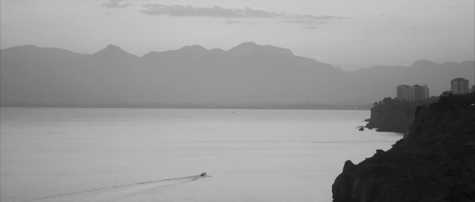 a black and white photo of a boat in the water