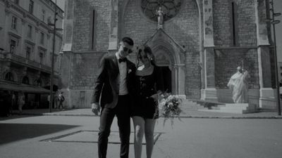 a man and a woman standing in front of a building