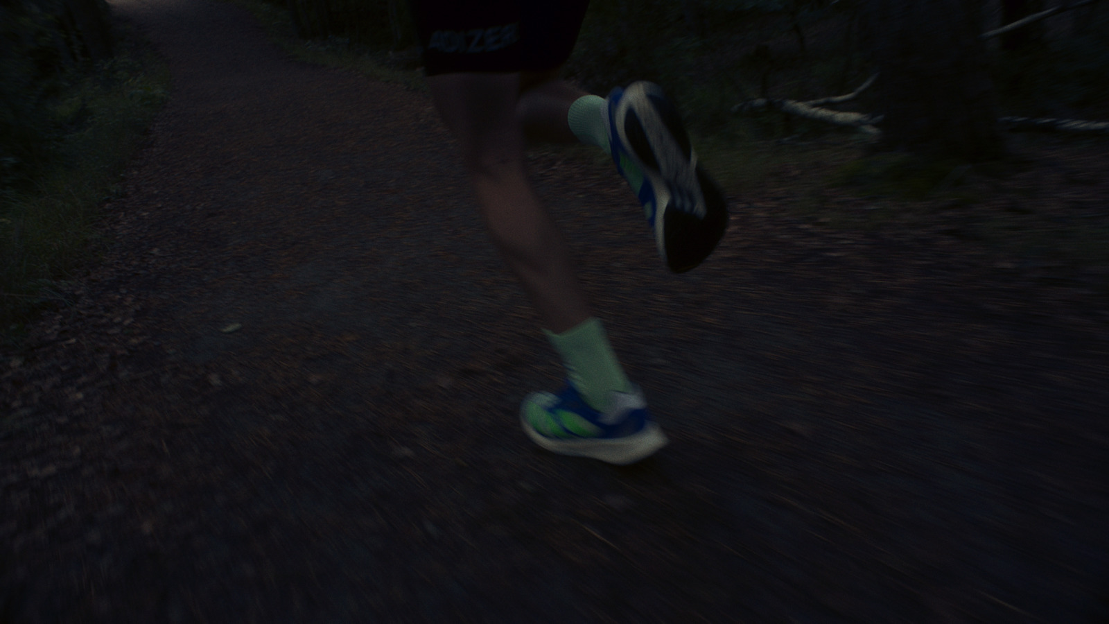 a person running down a trail at night