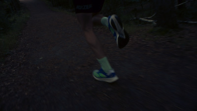 a person running down a trail at night