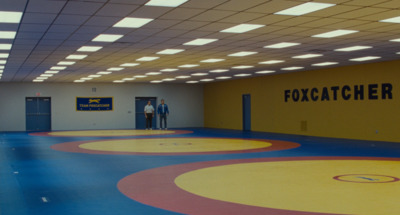 two men standing in the doorway of a gym