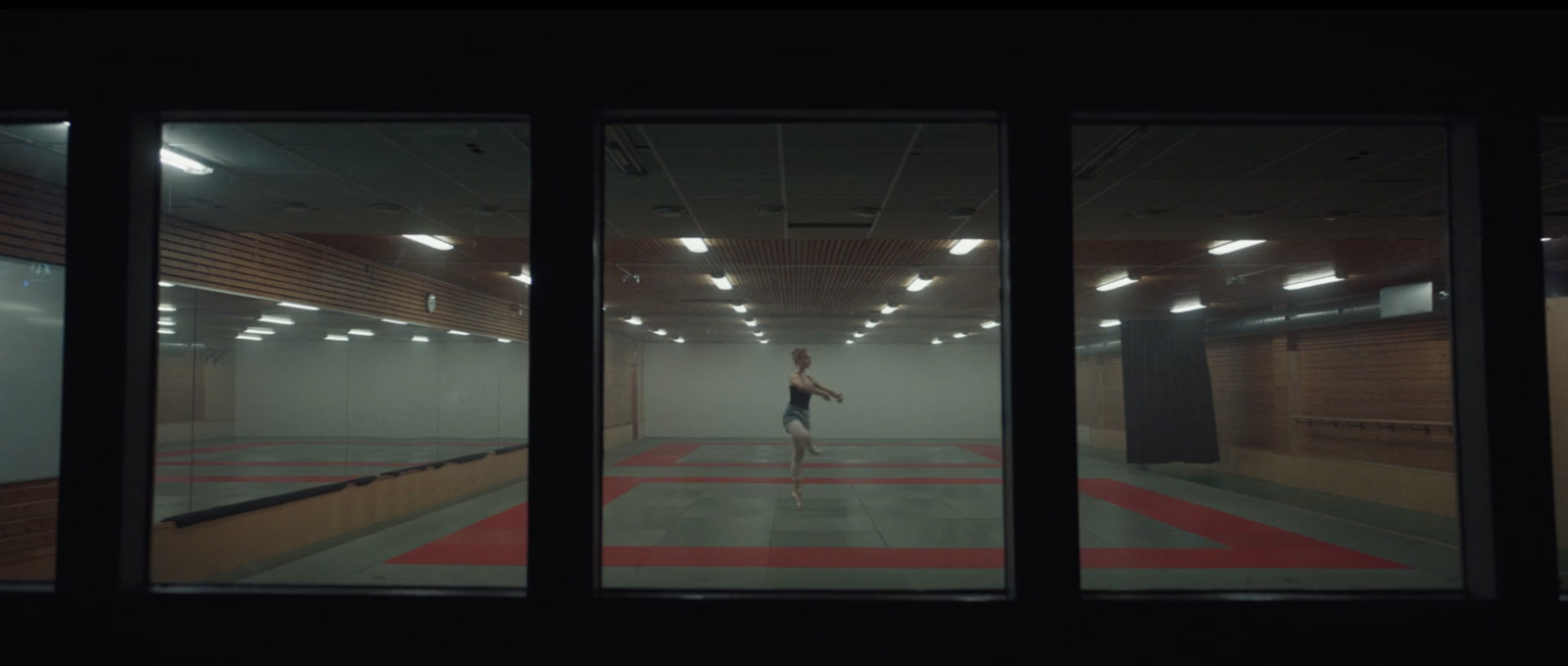 a person standing in a room with a red and white floor