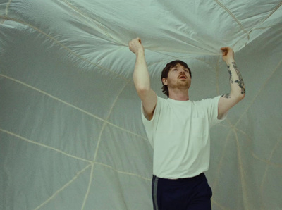 a man holding a white sheet over his head