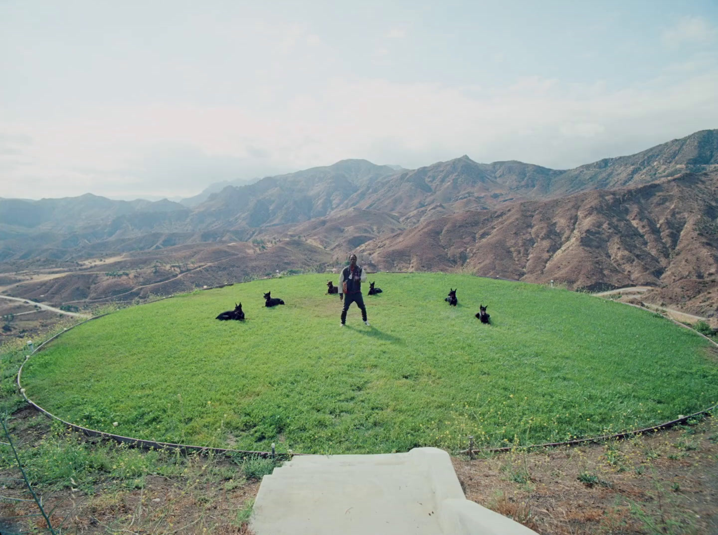 a man standing on top of a lush green field