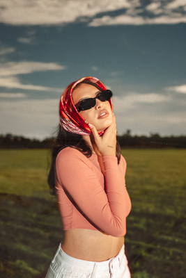 a woman wearing sunglasses and a red scarf