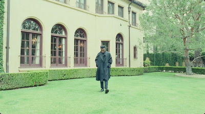 a man standing in front of a large building