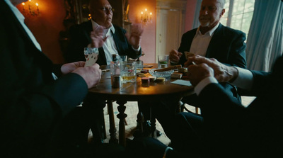 a group of men sitting around a wooden table