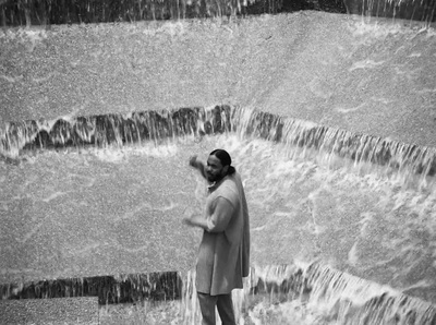 a man standing in front of a waterfall