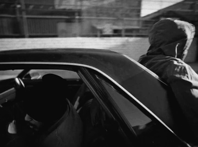 a person sitting in a car with a hood up