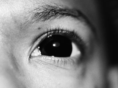 a black and white photo of a person's eye