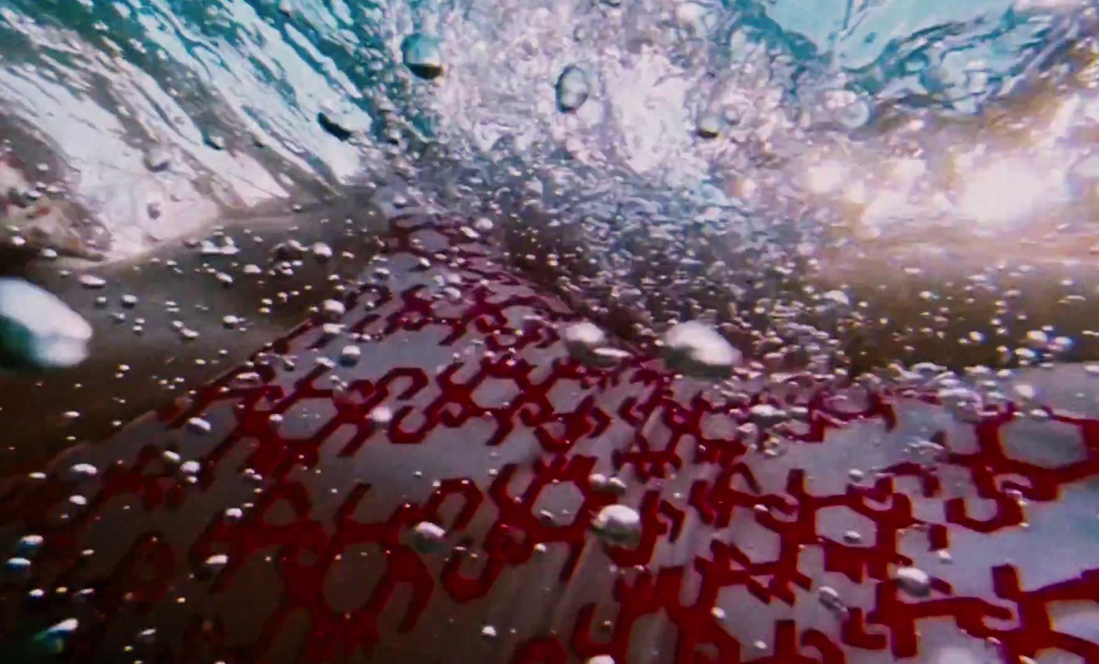 a close up of a red object in the water