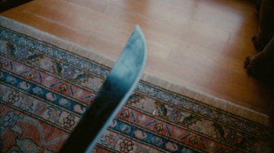 a knife is laying on a rug on the floor