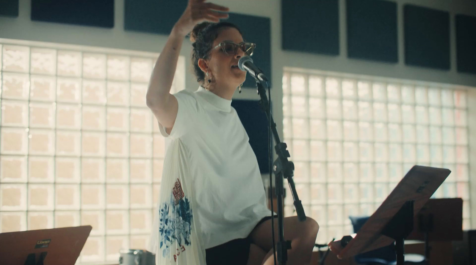 a woman standing in front of a microphone