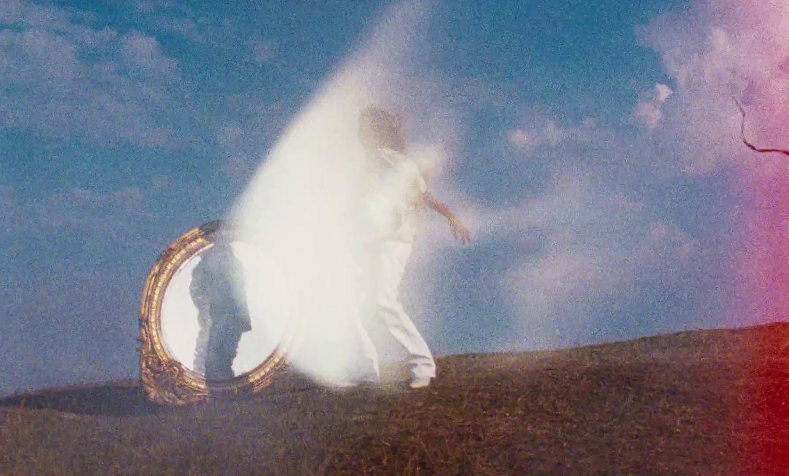 a man standing on top of a hill next to a fire hydrant